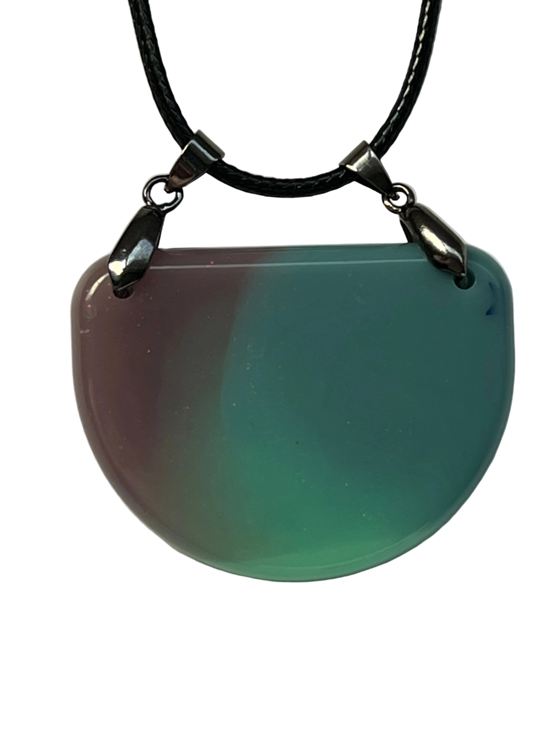 Handcrafted half moon resin pendant with blended dusty rose, teal, and seafoam green pigments and a hidden blue star inclusion, suspended from a black braided cord with dual silver-toned bails.