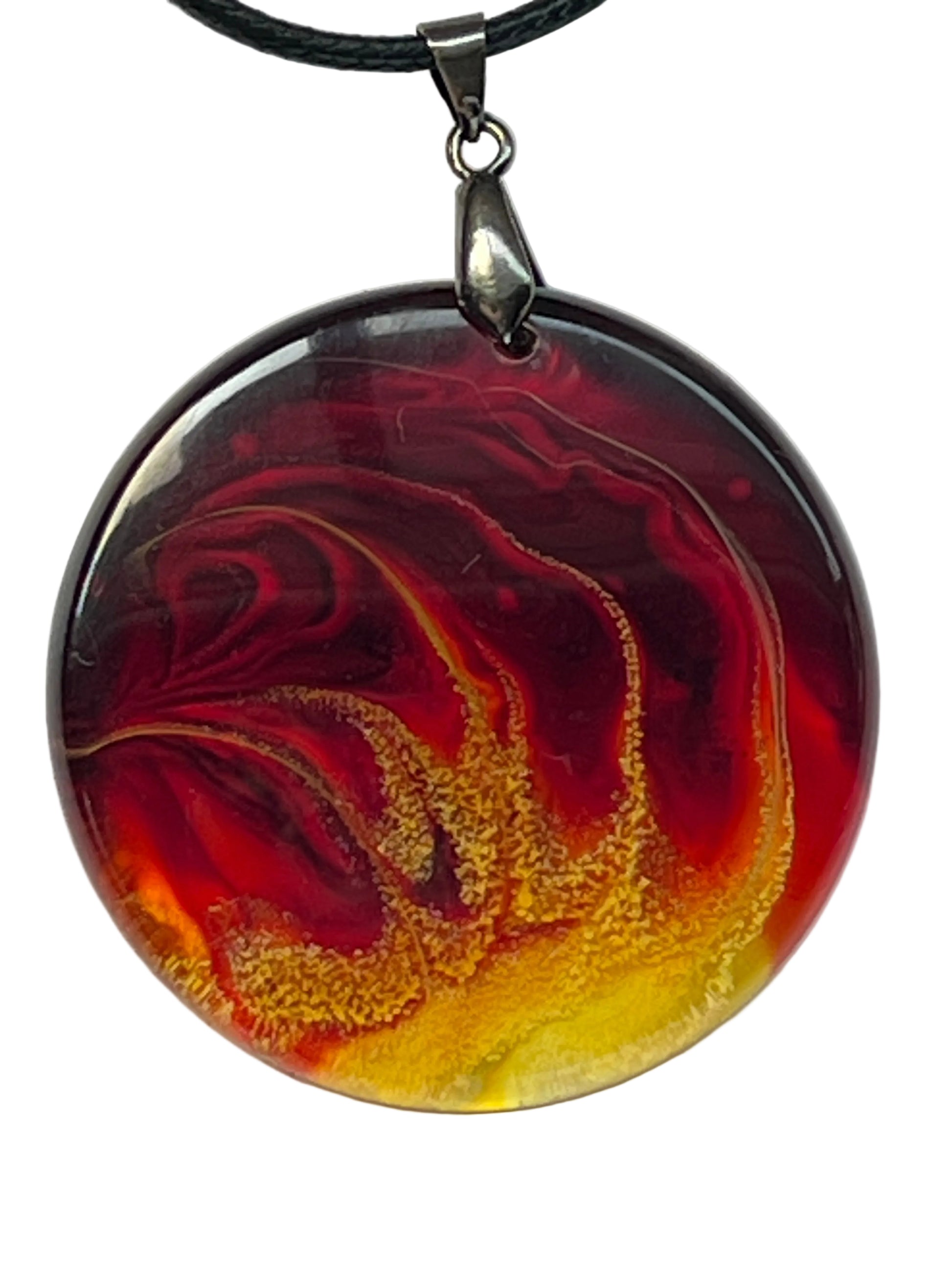 Handcrafted circle resin pendant with deep crimson and orange marbled swirls and an electric yellow and gold glitter core, suspended from a silver chain with a silver-toned bail.