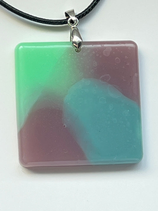 Handcrafted square resin pendant with soft swirling mint green, dusty rose, and ocean blue opaque pigments, suspended from a silver chain with a silver-toned bail.