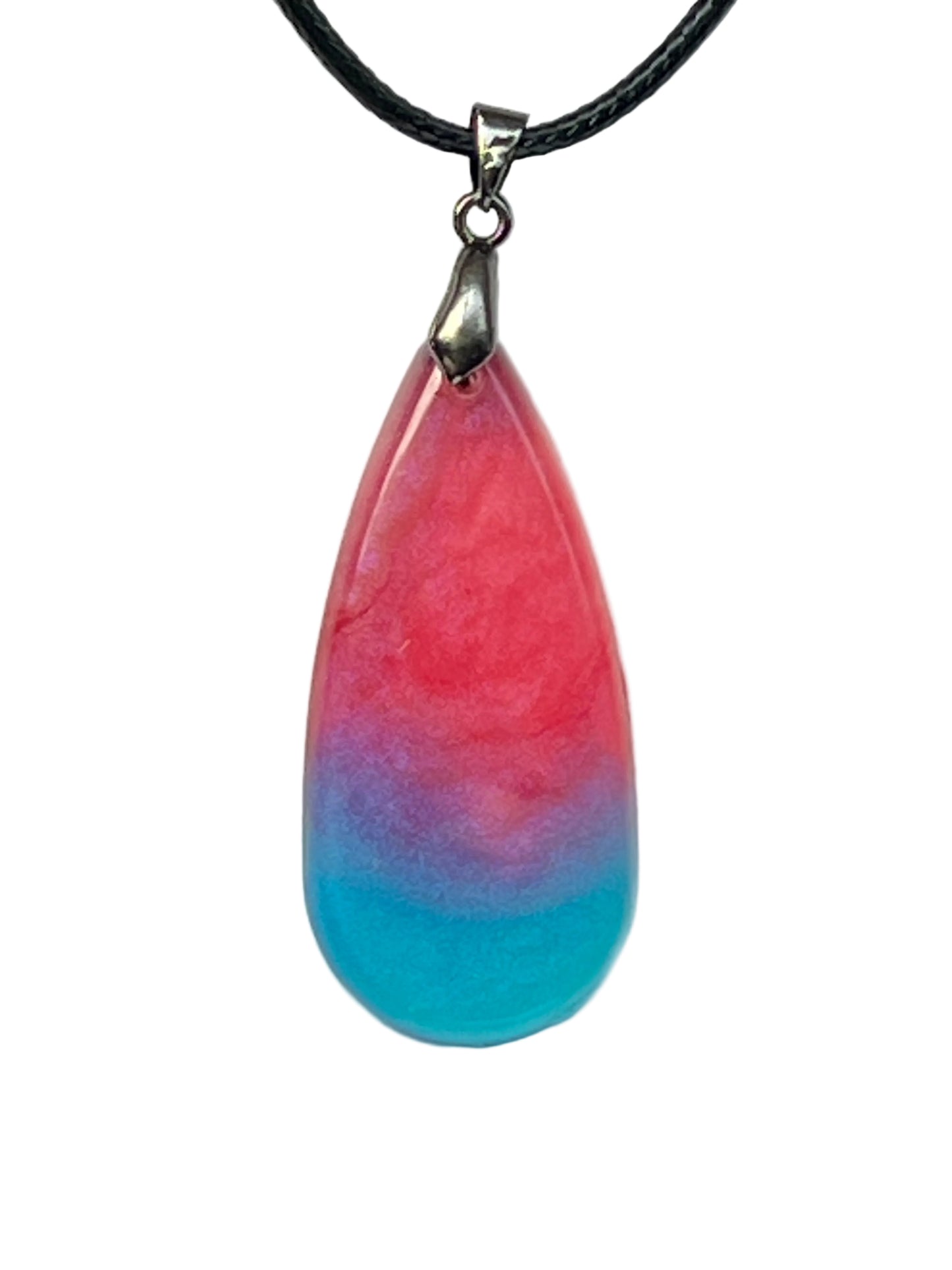 Handcrafted teardrop resin pendant with deep magenta marbled pink veining fading through violet into a turquoise base, suspended from a black braided cord with a silver-toned bail.