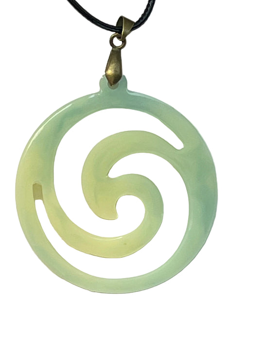 Handcrafted open cutwork spiral circle resin pendant with a soft cream center graduating to mint and seafoam green, suspended from a chain with an antique gold-toned bail.