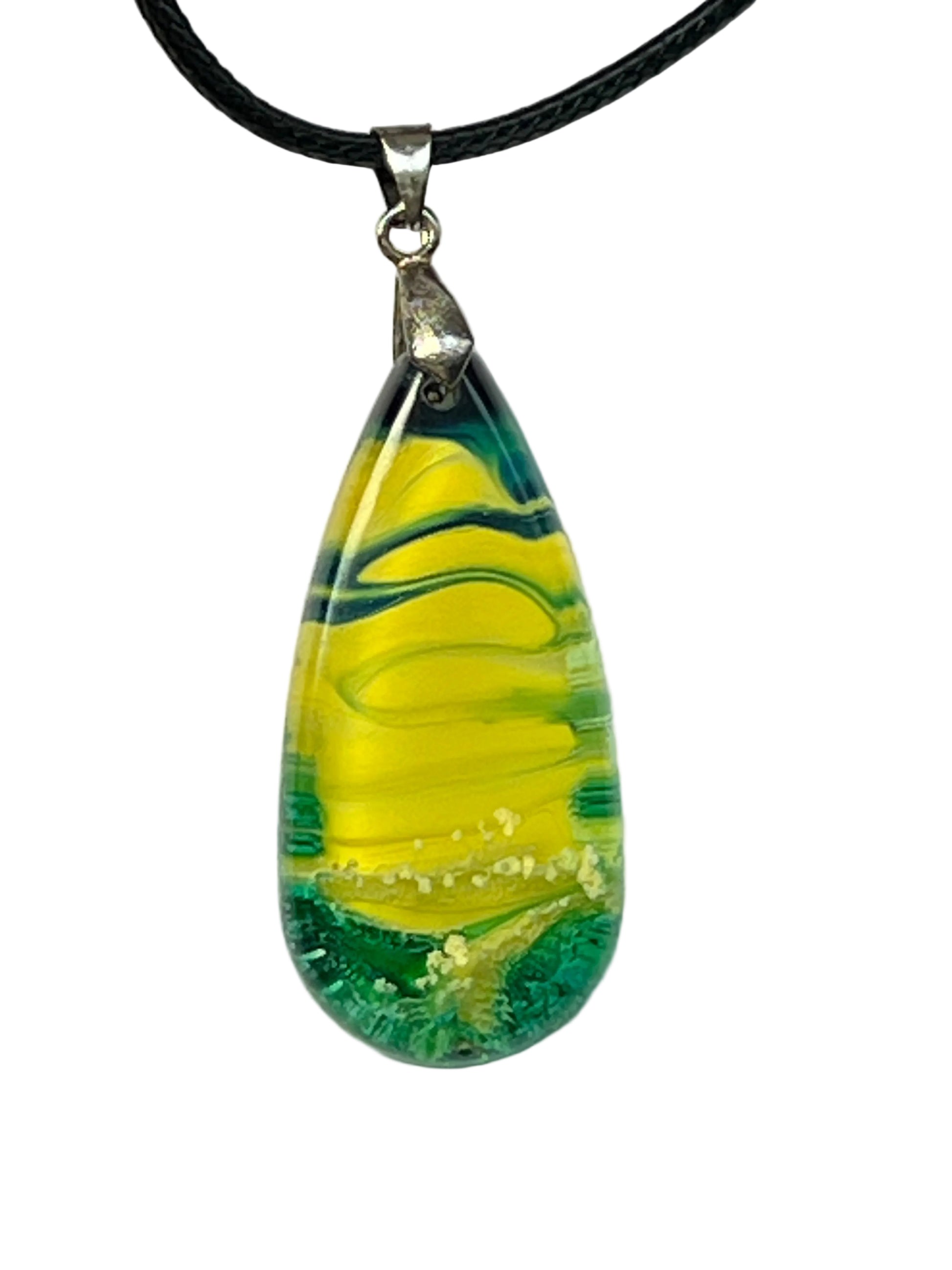 Handcrafted teardrop resin pendant with electric yellow center ribboned with deep forest green swirls and a textured teal base, suspended from a black braided cord with a silver-toned bail.
