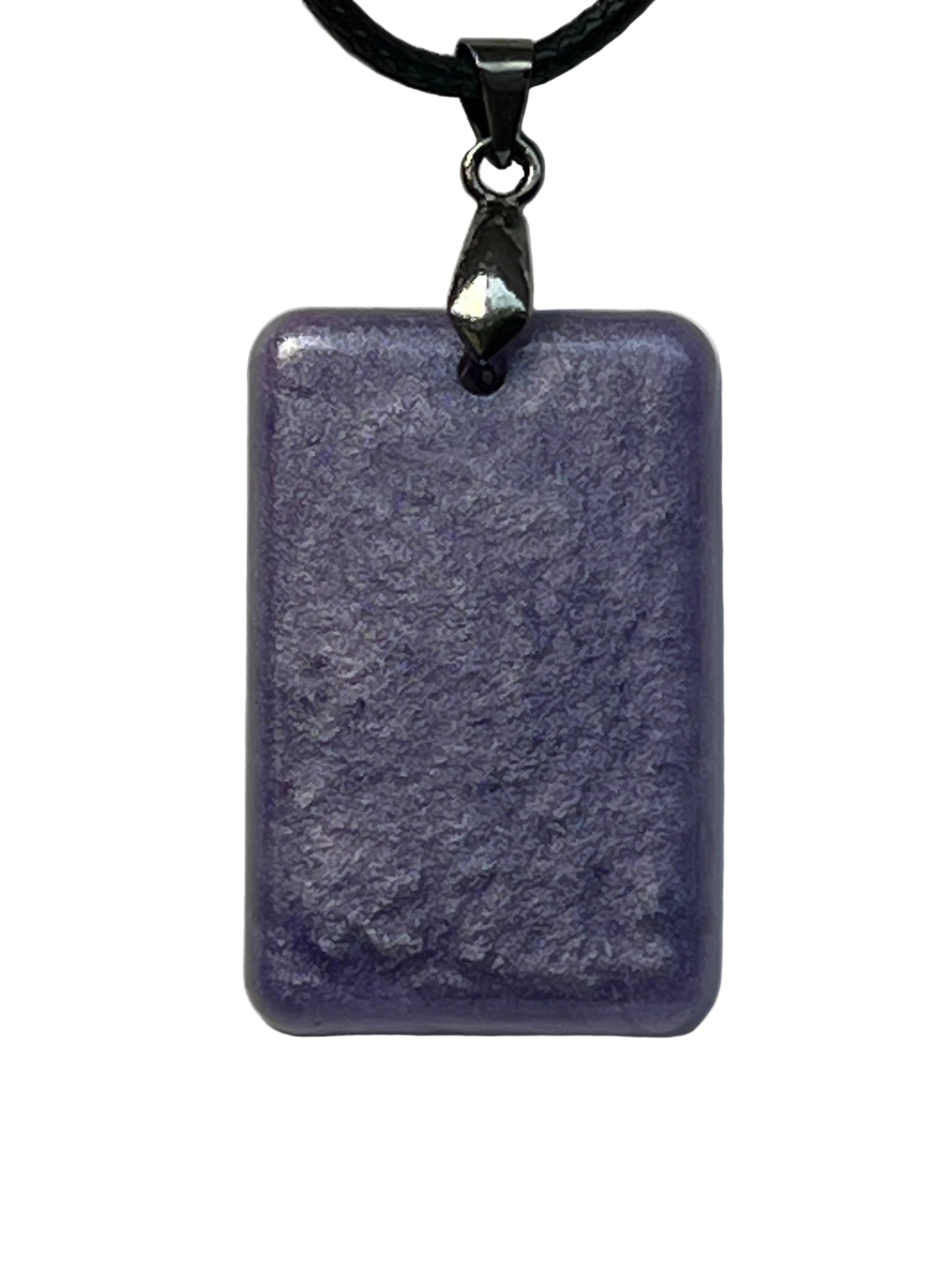Handcrafted deep dusty violet resin rounded rectangle pendant with subtle matte mineral texture, suspended from a black braided cord with a gunmetal bail.
