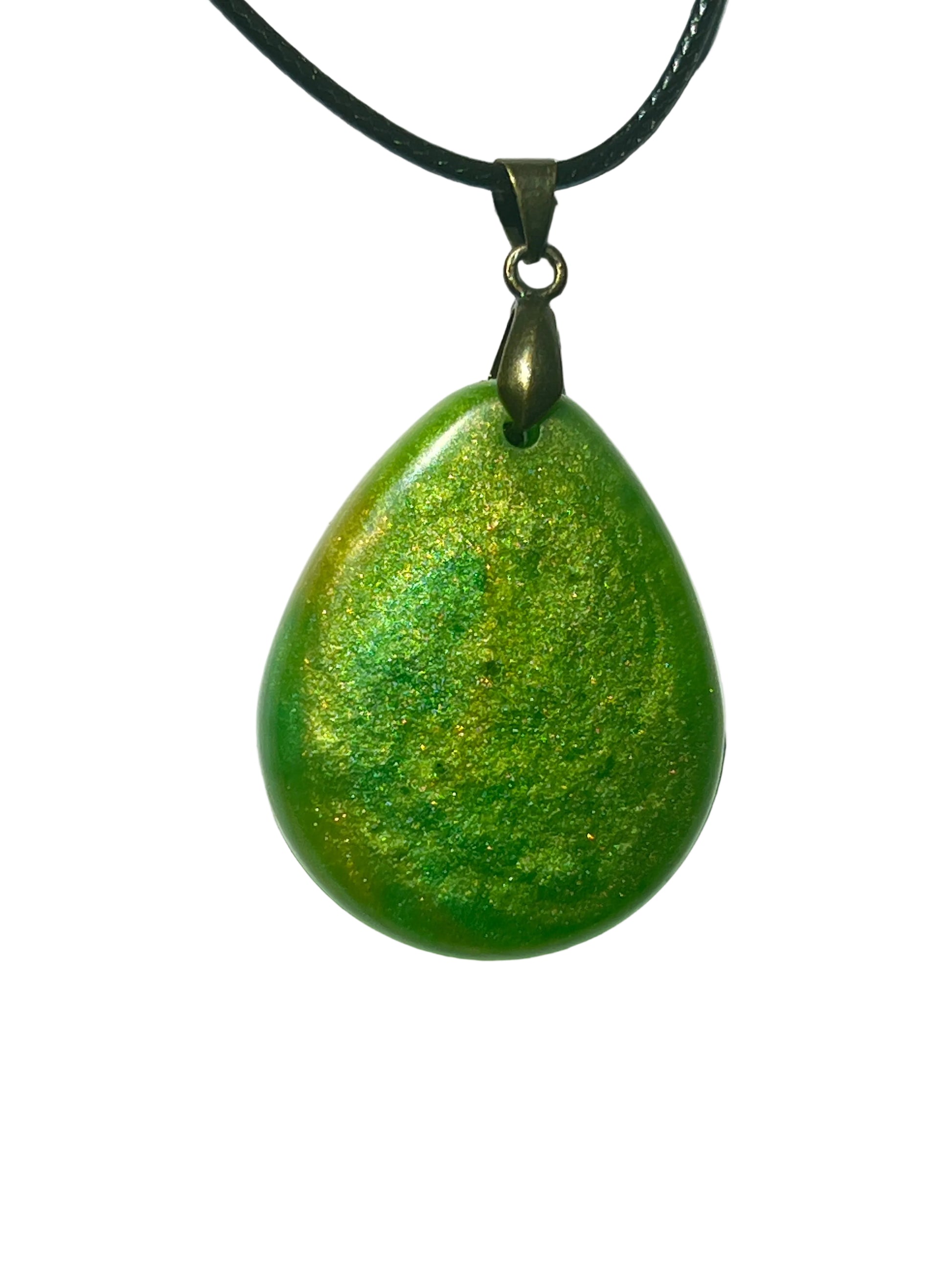 Handcrafted rich opaque emerald green resin wide teardrop pendant with swirling gold and chartreuse shimmer throughout and a domed iridescent surface, suspended from a black braided cord with an antique bronze bail.