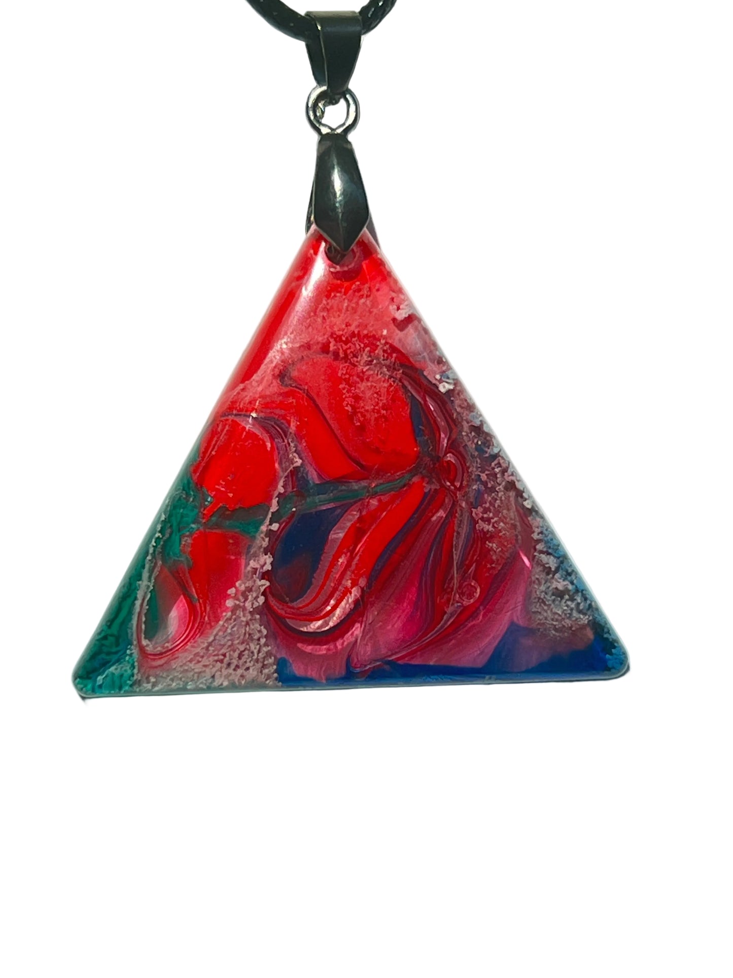 Handcrafted resin triangle pendant with blazing crimson and scarlet swirls, vivid teal, deep cobalt blue, and violet ribbon details with white foam texture throughout, suspended from a black braided cord with a gunmetal bail.