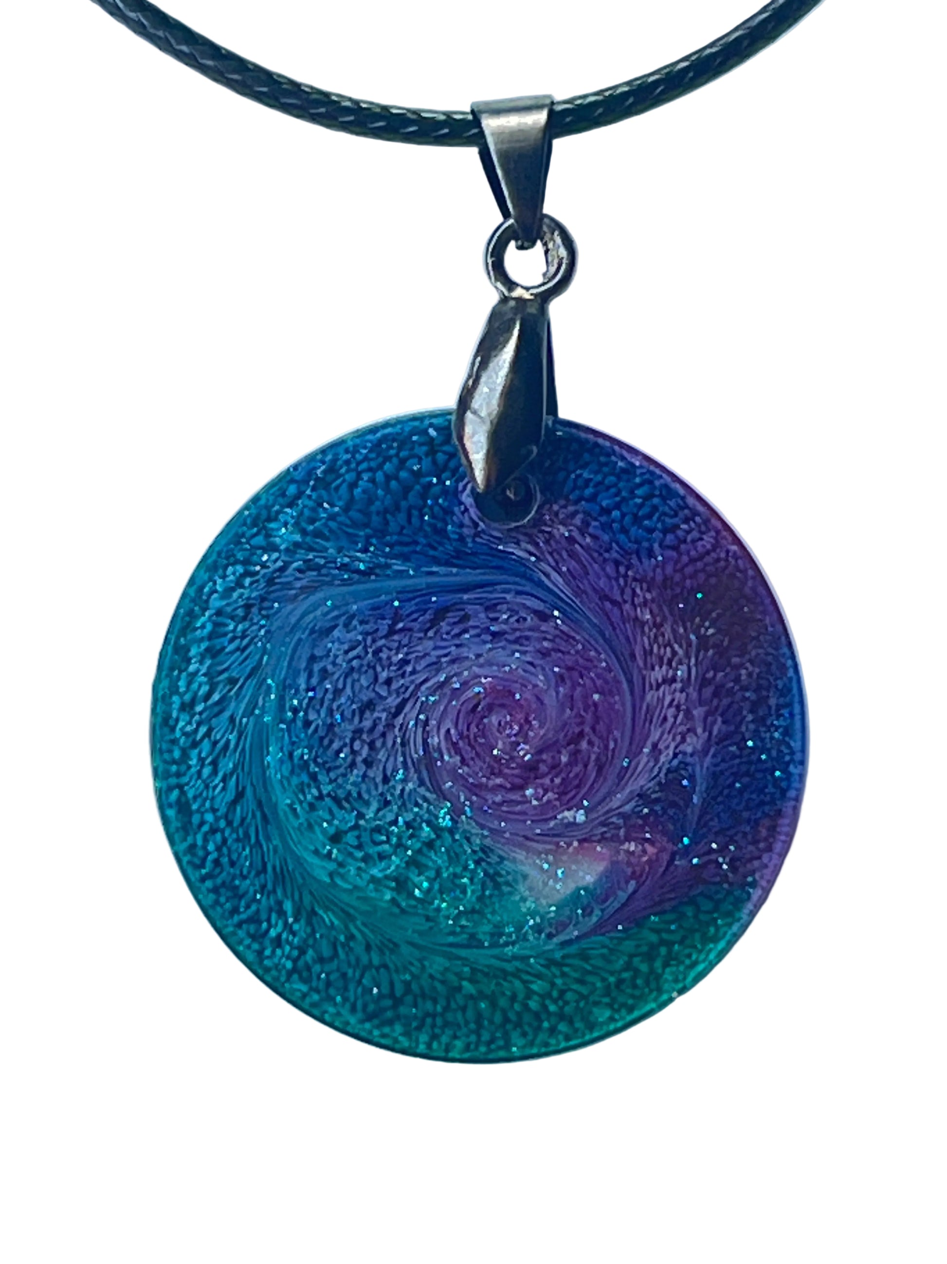 Handcrafted resin large circle pendant with a swirling violet and lavender center vortex surrounded by vivid teal and turquoise with fine iridescent glitter and extraordinary cellular texture throughout, suspended from a chain necklace with a silver-toned bail.