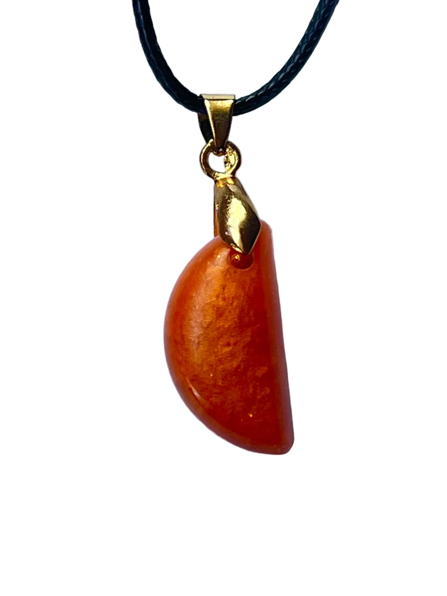 Handcrafted deep carnelian and burnt orange resin curved fang or claw shaped pendant with matte stone-like finish and subtle tonal variation, suspended from a black braided cord with a gold-toned bail.
