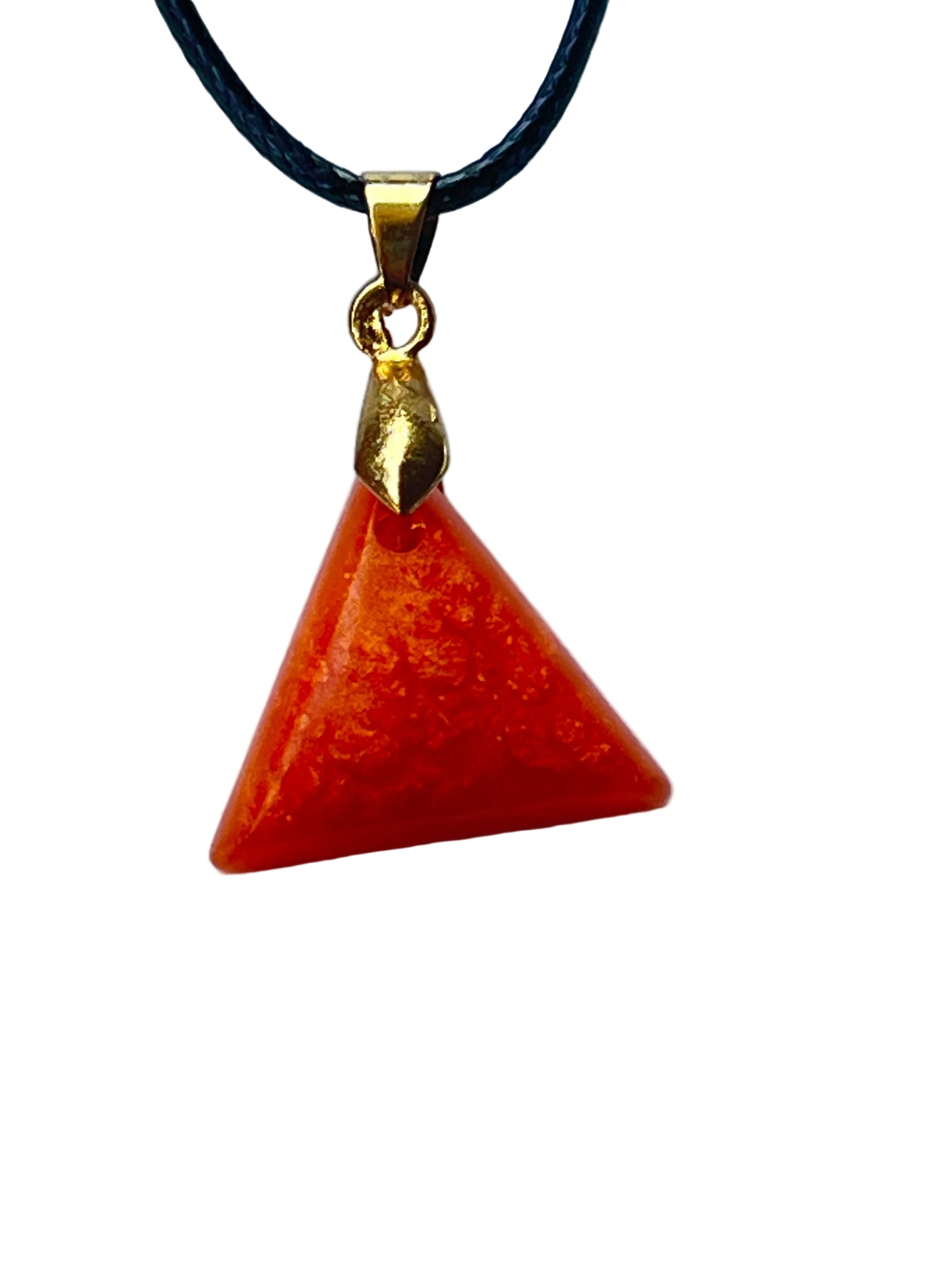 Handcrafted rich saturated carnelian orange resin triangle pyramid pendant with fine gold shimmer in the upper field and an opaque stone-like finish, suspended from a black braided cord with a gold-toned bail.