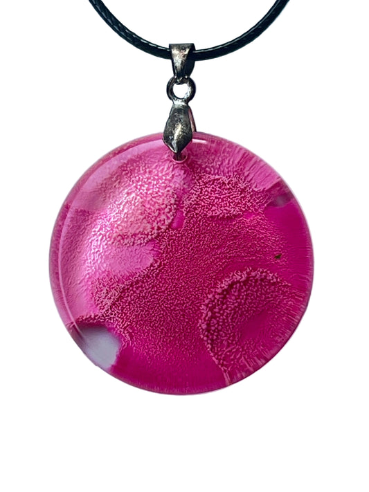 Handcrafted rich hot pink and magenta resin large circle pendant with fine organic cellular texture throughout and subtle tonal variation from deep magenta to soft blush, suspended from a black braided cord with a silver-toned bail.