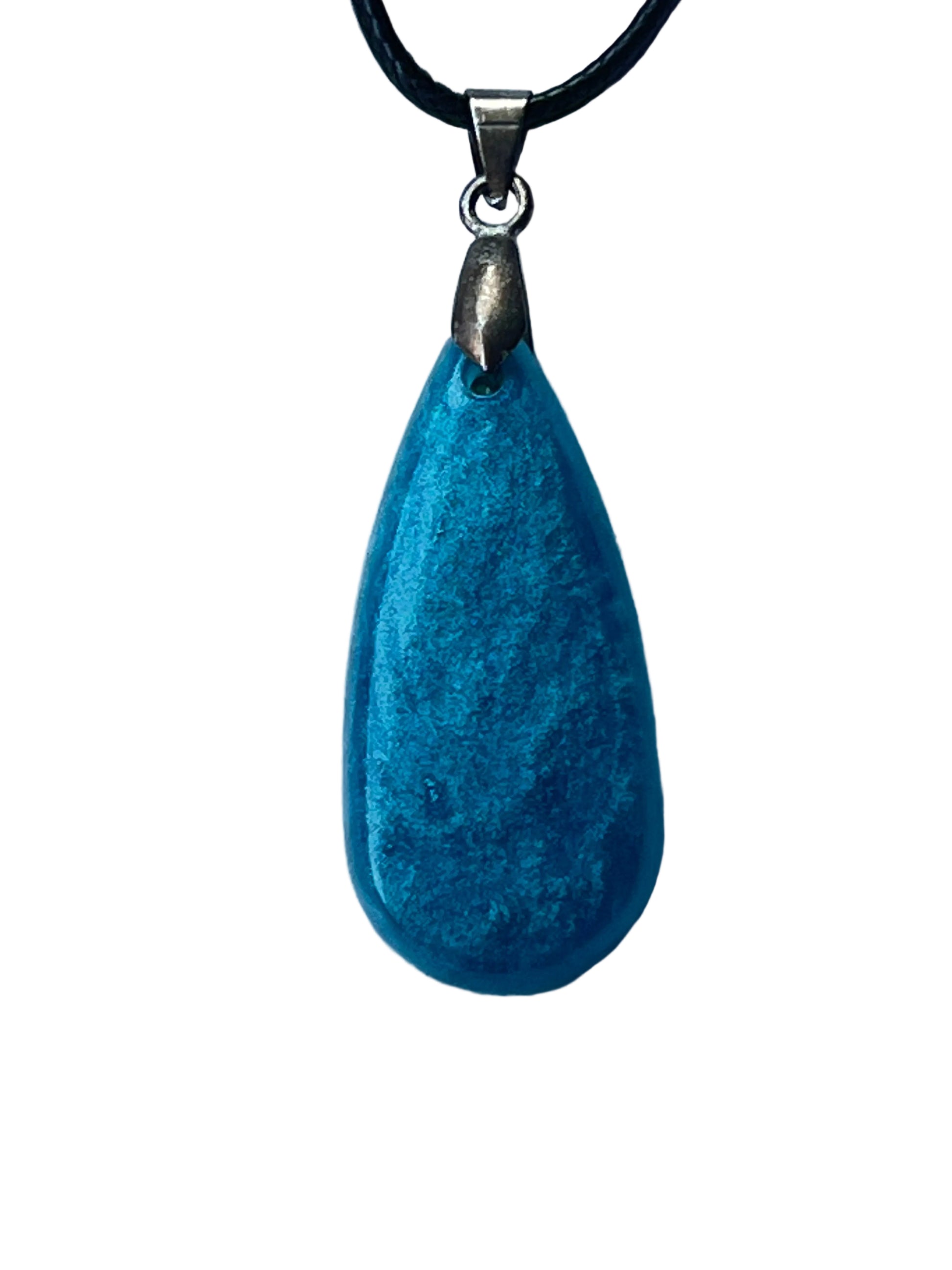 Handcrafted rich matte turquoise resin elongated teardrop pendant with fine mineral texture and subtle teal variation throughout giving a polished stone-like quality, suspended from a black braided cord with a silver-toned bail.