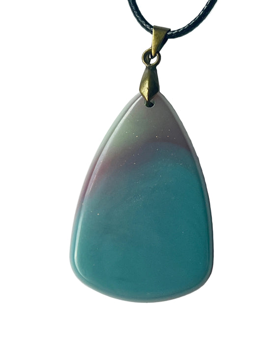 Handcrafted large resin teardrop pendant with soft milky opalescent teal lower field fading seamlessly into dusty mauve and grey-violet upper tones with scattered fine white and silver glitter, suspended from a black braided cord with an antiqued brass bail.