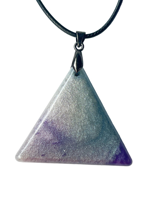 Handcrafted resin equilateral triangle pendant with dense ultra-fine silver shimmer throughout and rich amethyst purple rising from both lower corners fading into a soft lavender center blend, with a high-gloss domed finish, suspended from a black braided cord with a gunmetal bail.