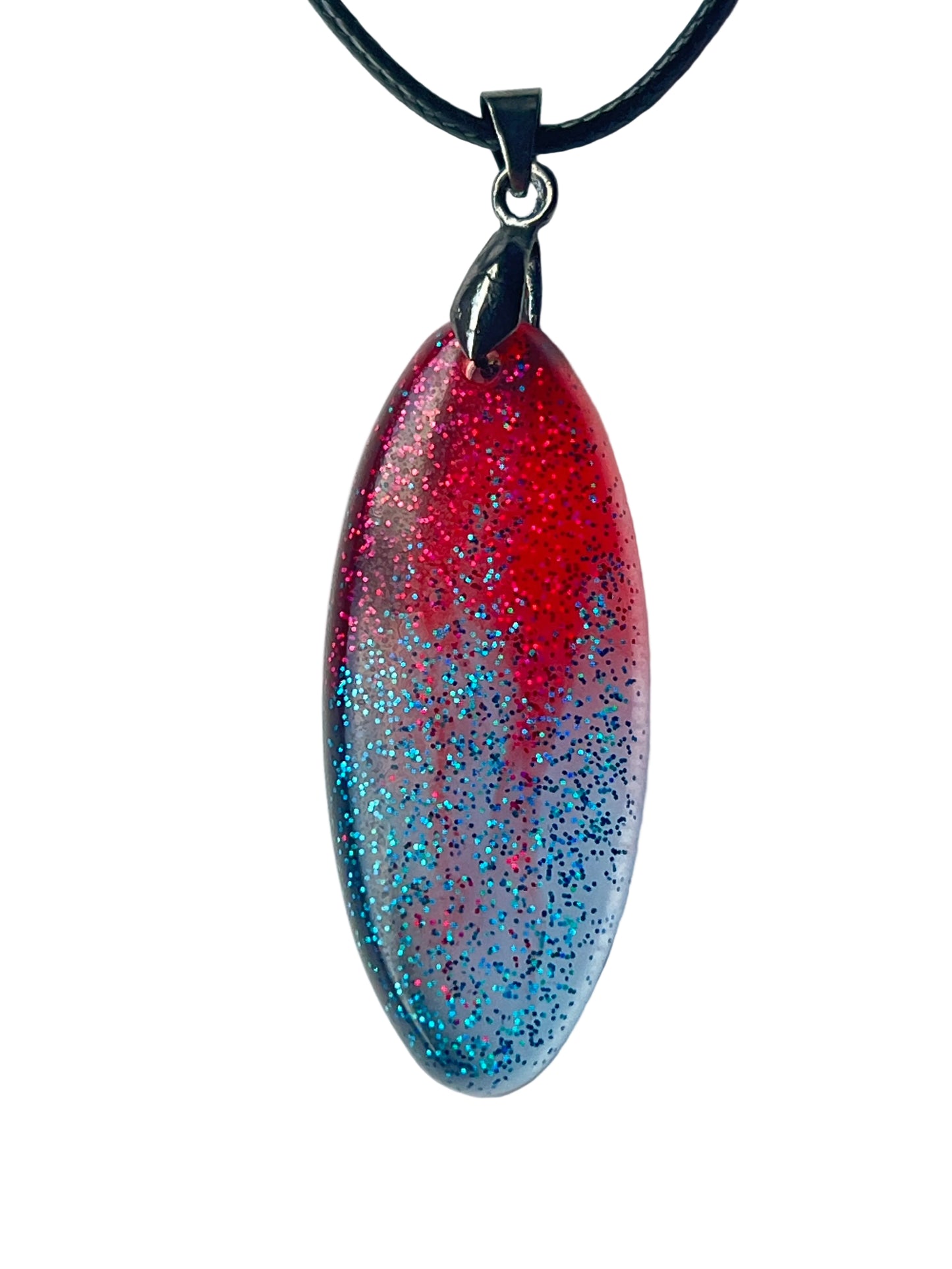 Handcrafted resin elongated marquise pendant with vivid translucent crimson upper field densely filled with magenta-red and pink glitter fading through mauve-purple into cool silver-lavender lower field with dense electric teal and blue glitter, suspended from a black braided cord with a gunmetal bail.