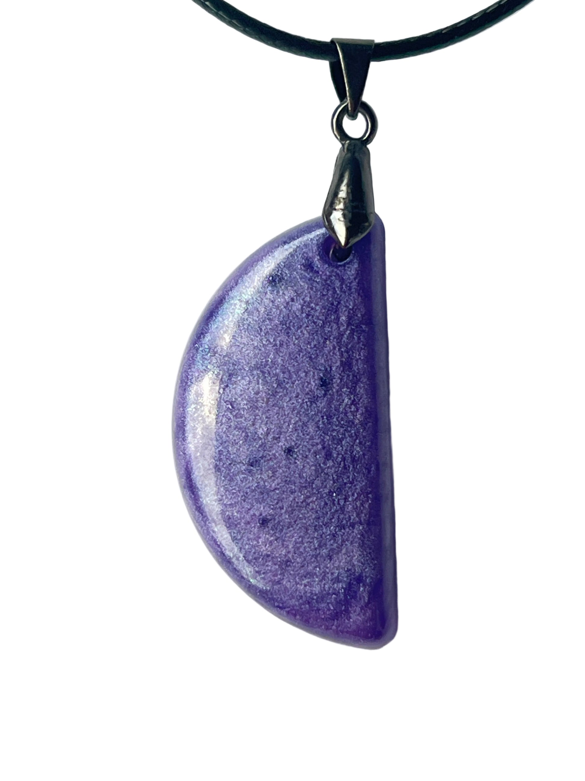 Handcrafted deep opaque violet-purple resin half-moon pendant with fine pearlescent silver-blue iridescent shimmer throughout and a high-gloss domed finish, suspended from a black braided cord with a gunmetal bail.