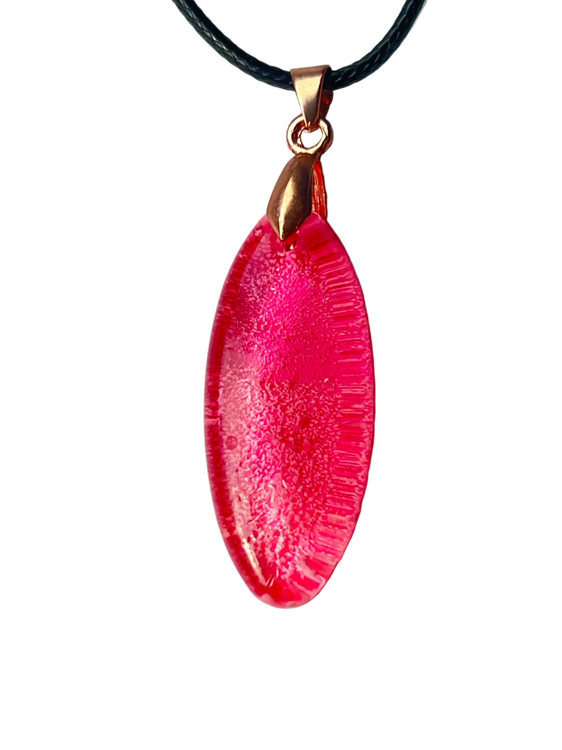 Handcrafted vivid translucent hot pink and magenta resin elongated marquise pendant with intricate fine radiating lace texture throughout and a high-gloss domed finish, suspended from a black braided cord with a rose gold bail.