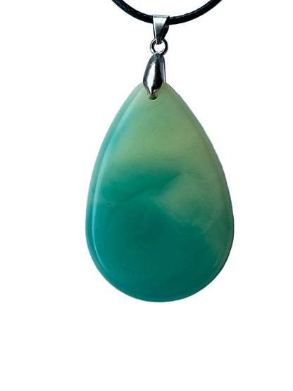 Handcrafted large resin teardrop pendant with soft celadon and pale mint upper field flowing through a milky organic gradient into rich saturated teal-green lower field with a ghostly white swirl in the transition zone, suspended from a black braided cord with a silver-toned bail.