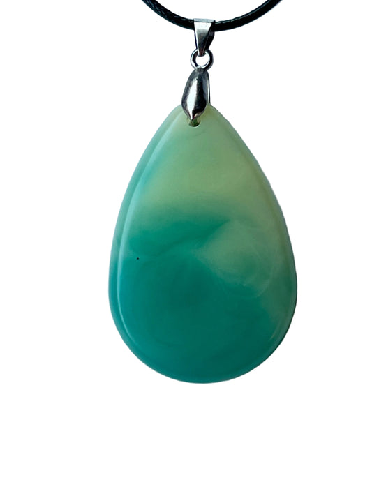 Handcrafted large resin teardrop pendant with soft celadon and pale mint upper field flowing through a milky organic gradient into rich saturated teal-green lower field with a ghostly white swirl in the transition zone, suspended from a black braided cord with a silver-toned bail.