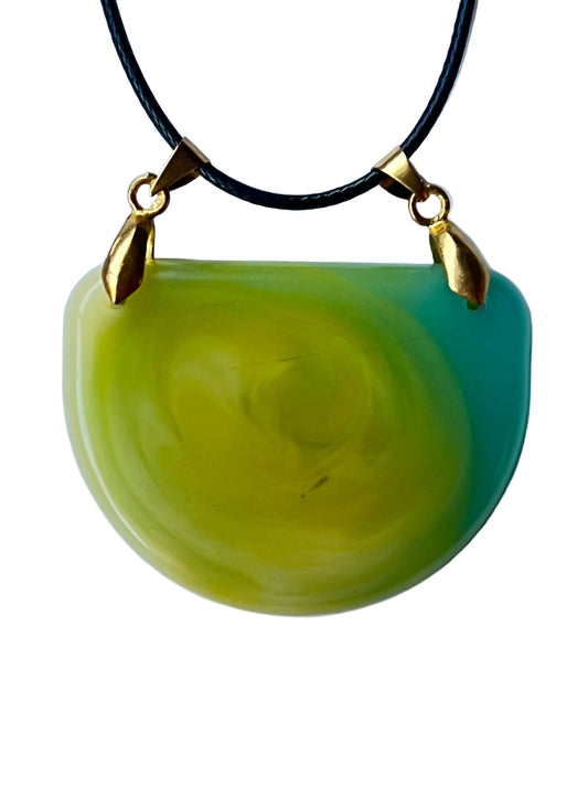 Handcrafted wide fan-shaped resin bib pendant in vivid chartreuse and yellow-green with organic swirling cream-yellow channels and a bright aqua-teal sweep along the upper right edge, suspended from a black braided cord via two gold-toned bails at the upper corners.