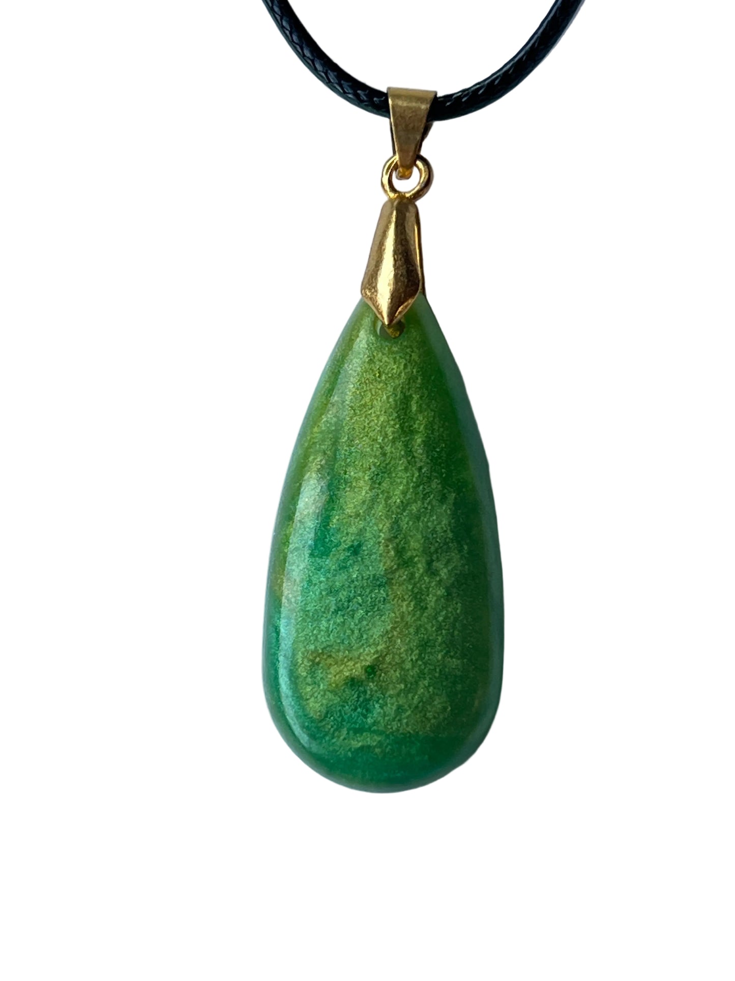 Handcrafted rich opaque forest and emerald green resin teardrop pendant with fine shifting gold and chartreuse shimmer throughout and a high-gloss deeply domed cabochon finish, suspended from a black braided cord with a gold-toned bail.