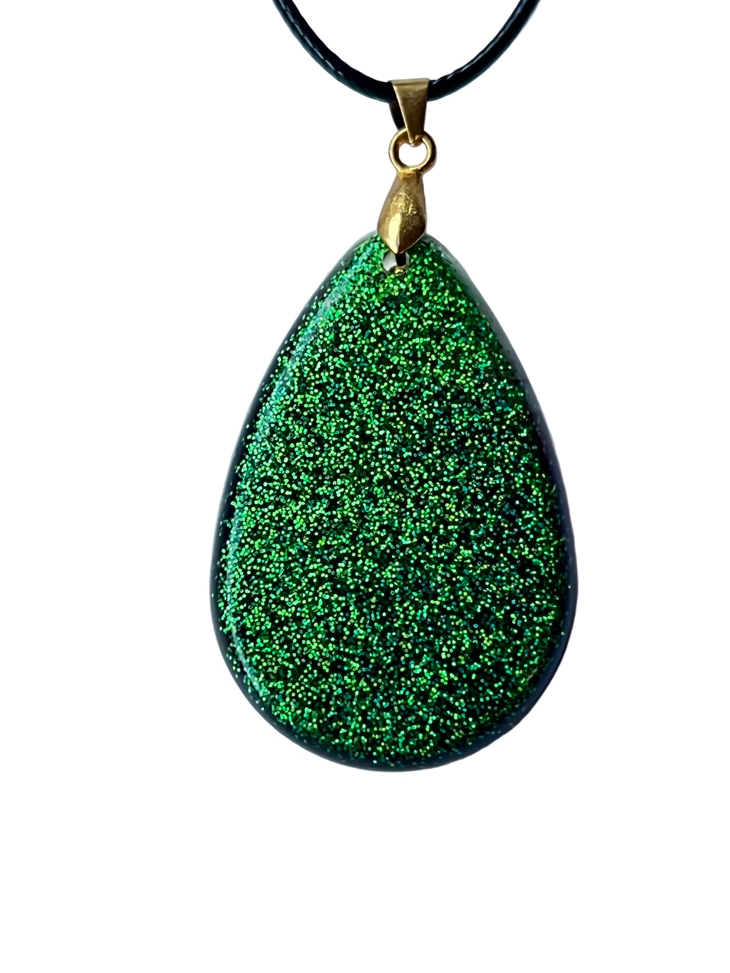 Handcrafted large resin teardrop pendant with deep opaque black base covered entirely in extraordinarily dense fine electric green glitter shifting between emerald and chartreuse-green, suspended from a black braided cord with a gold-toned bail.
