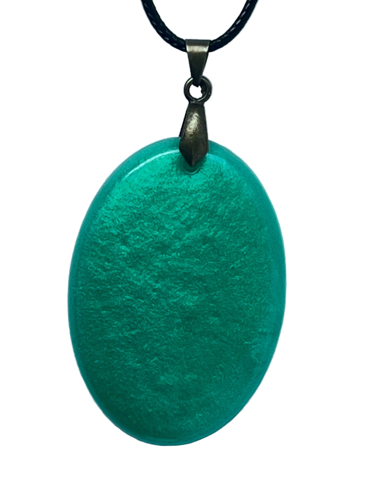 Handcrafted rich opaque teal-green resin oval pendant with fine pearlescent shimmer throughout, suspended from a black braided cord with an antiqued brass bail.