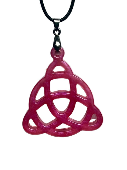 Handcrafted vivid fuchsia and deep rose pink resin triquetra Celtic knot pendant with open cutwork structure and translucent blush interior windows, suspended from a black braided cord with a gunmetal bail.