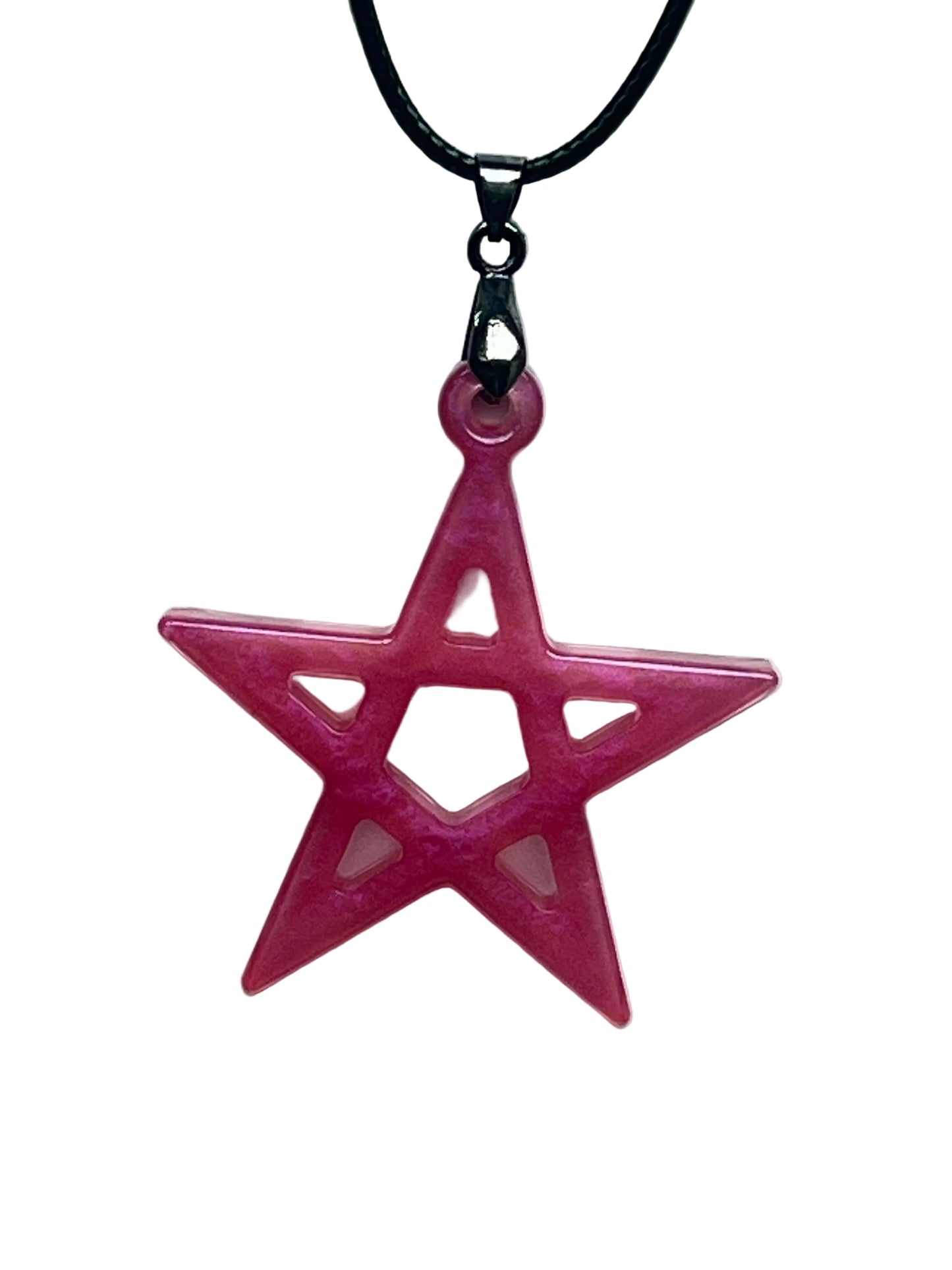Handcrafted vivid fuchsia and deep rose pink resin five-pointed star pentagram pendant with open cutwork structure and translucent blush interior windows, suspended from a black braided cord with a gunmetal bail.