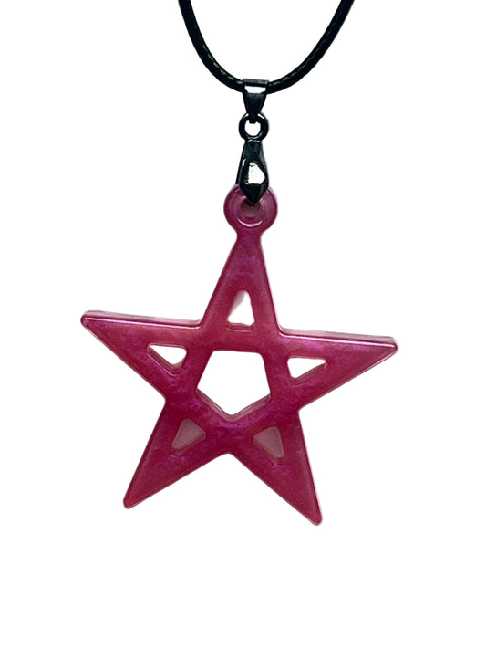 Handcrafted vivid fuchsia and deep rose pink resin five-pointed star pentagram pendant with open cutwork structure and translucent blush interior windows, suspended from a black braided cord with a gunmetal bail.
