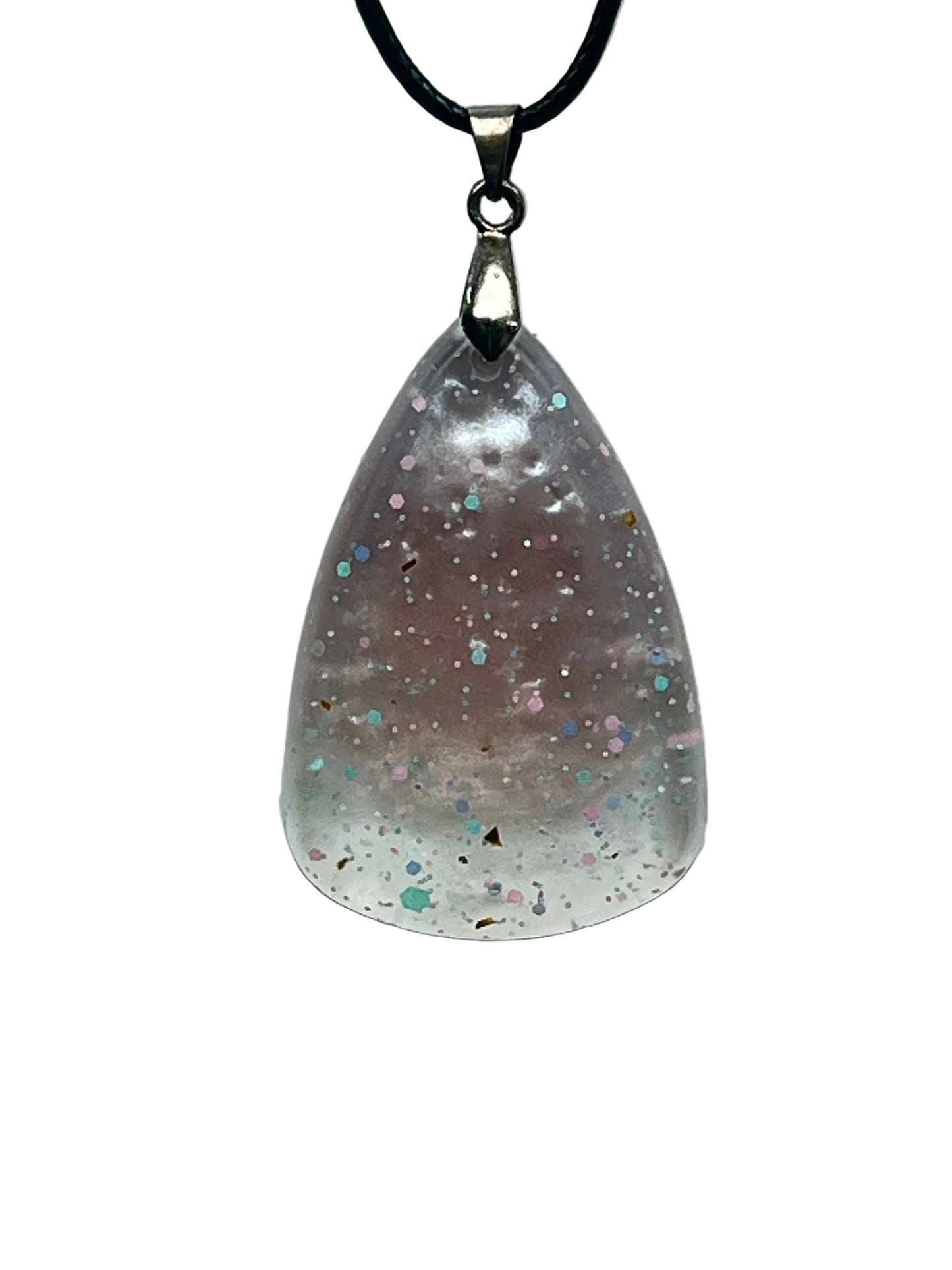 A teardrop-shaped resin pendant that fades from a soft dusty mauve at the top to frosted clear white at the rounded base, scattered with confetti flecks in pink, mint, blue, and gold. It hangs from a silver-toned bail on a black braided cord against a pale background.