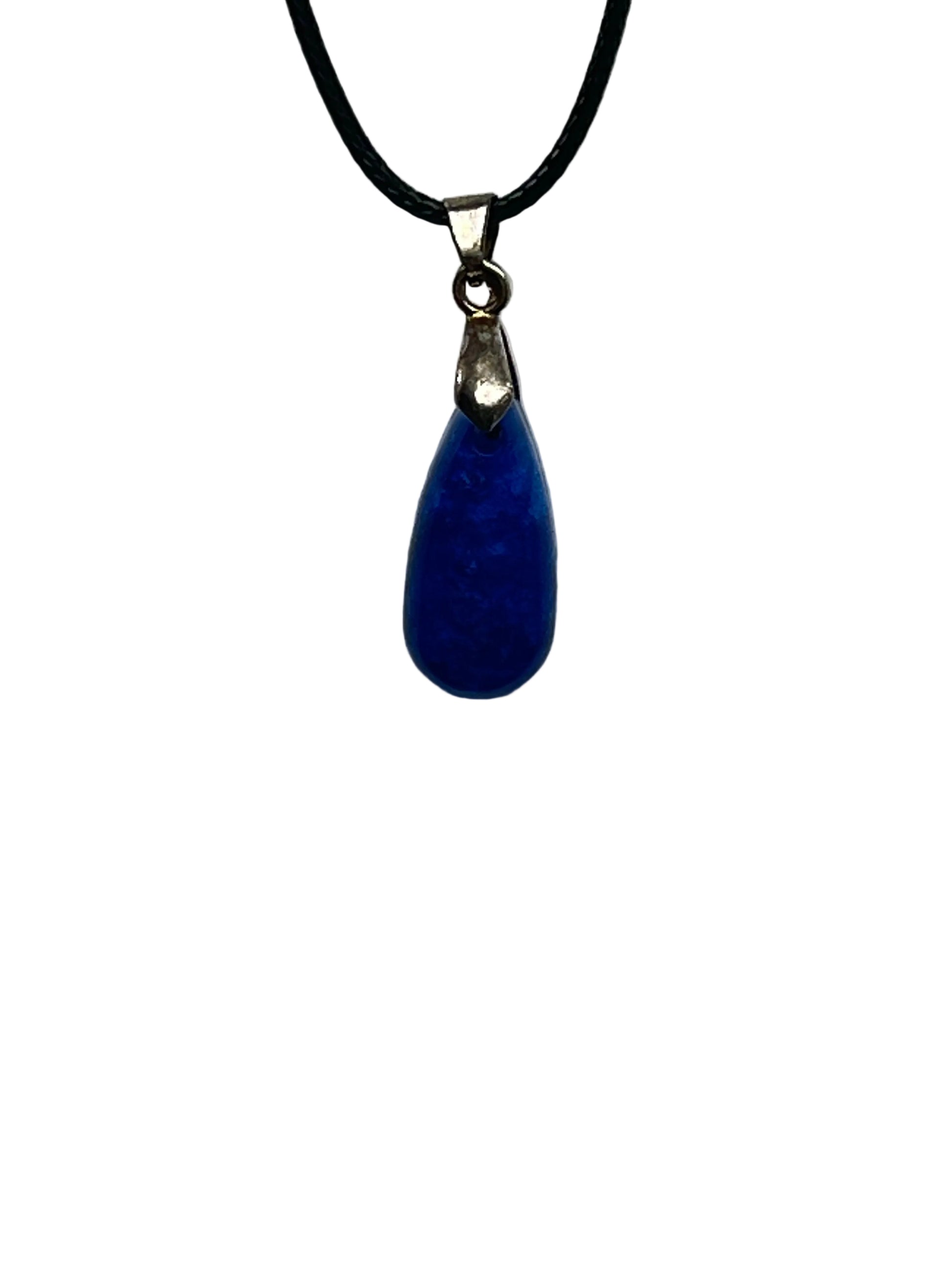 A slender, elongated teardrop-shaped resin pendant in deep cobalt and royal blue with soft cloud-like swirls of lighter and darker blue. It hangs from a silver-toned bail on a black braided cord against a pale background.
