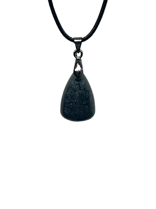 A smooth teardrop-shaped resin pendant in charcoal grey with a soft, mottled, smoke-like texture and faint silvery shimmer. It hangs from a gunmetal bail on a black braided cord against a pale background.