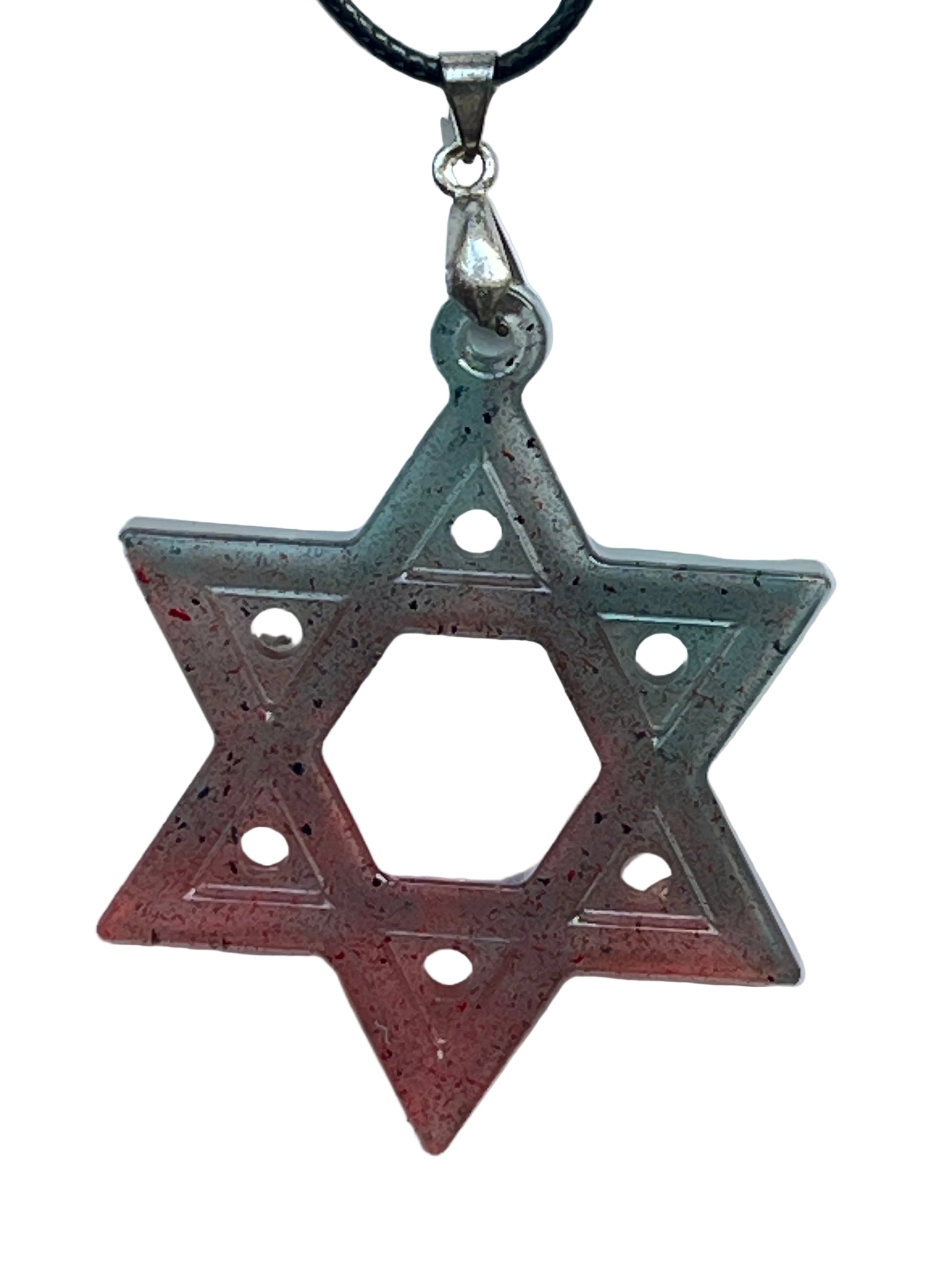A six-pointed star (hexagram) resin pendant with a gradient from teal and slate at the top points to coral and red at the bottom, scattered with fine black speckles, a single dot on each point, and an open hexagonal center. It hangs from a silver-toned bail on a black braided cord against a pale background.