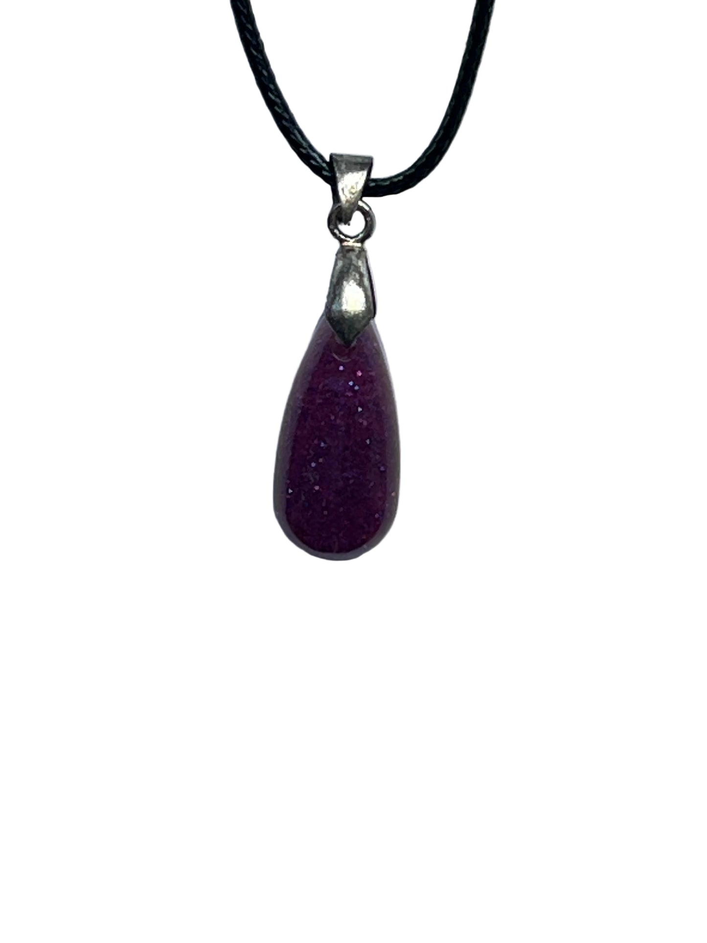 A small, elongated teardrop-shaped resin pendant in a rich plum purple with a fine glittery shimmer throughout. It hangs from a silver-toned bail on a black braided cord against a pale background.