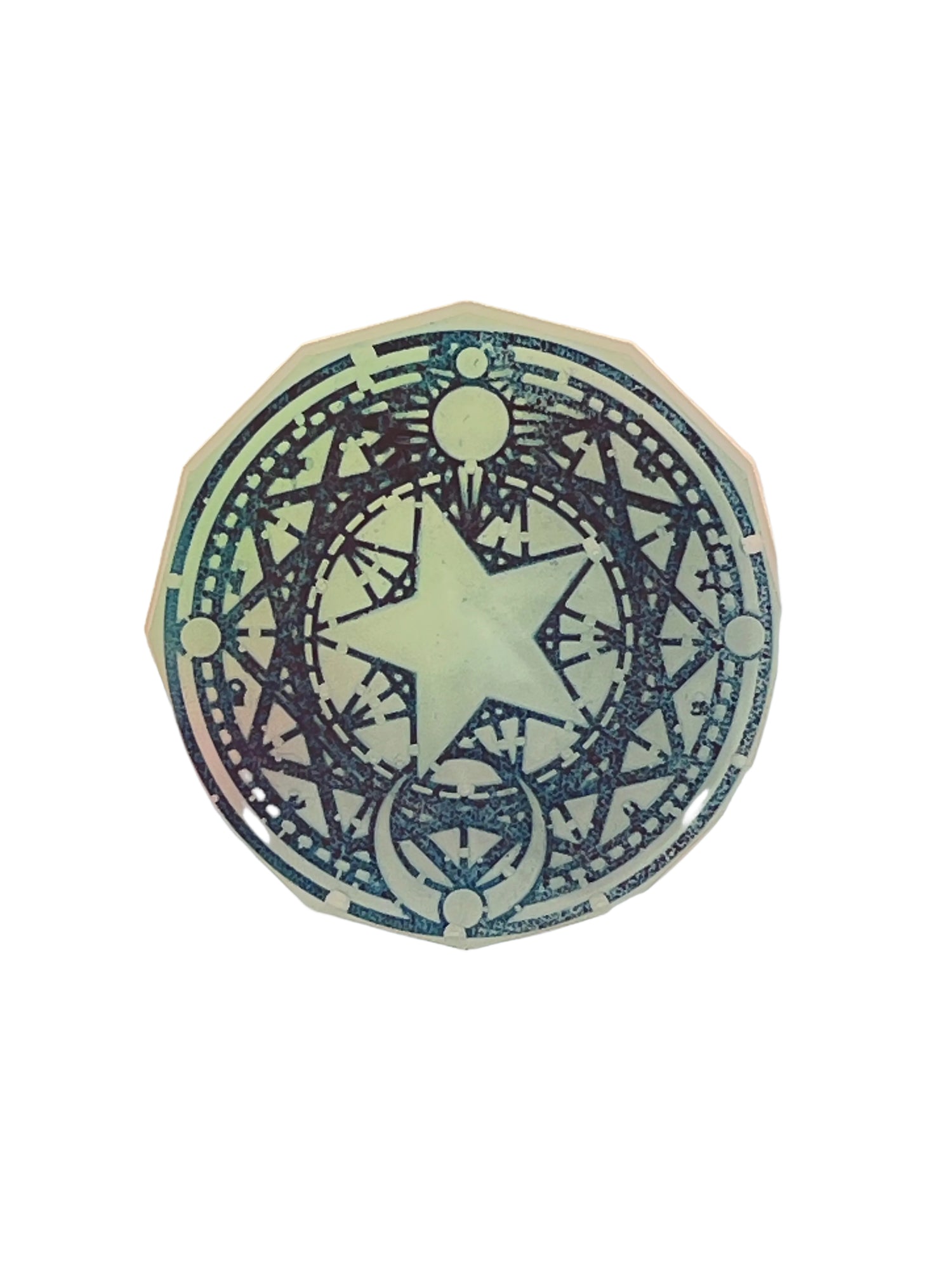 Round resin talisman in shimmering seafoam and mauve with a dark indigo five-pointed star and celestial symbol design.