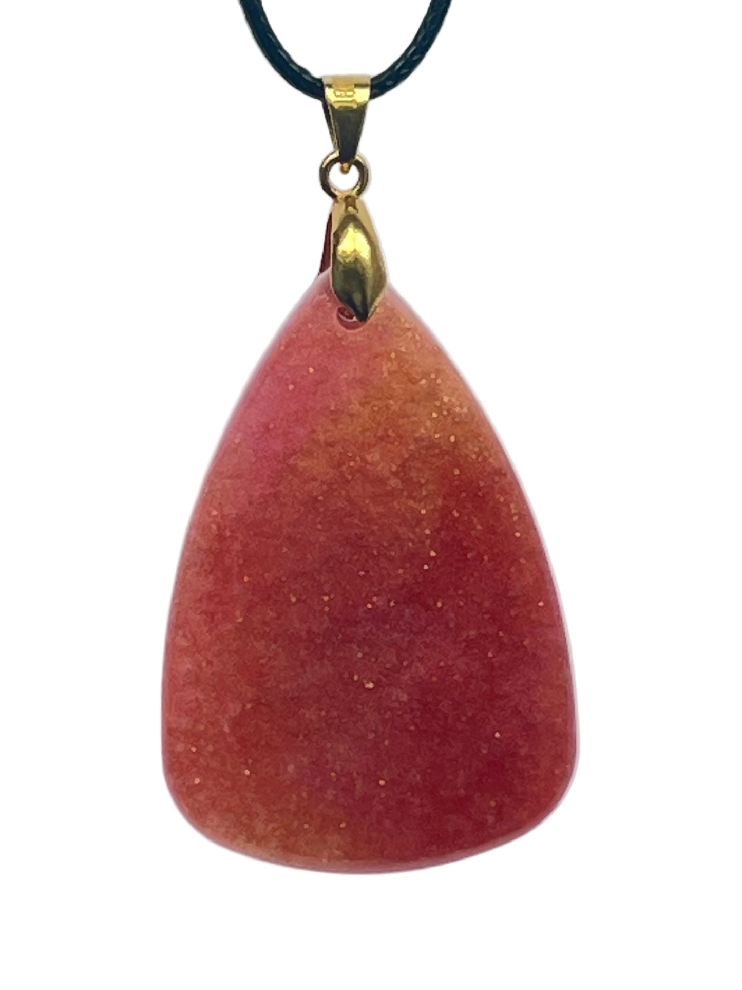 An organic, rounded triangular-shaped resin pendant with a gradient from burnt orange and rust at the base to softer peach at the top, scattered throughout with fine gold sparkle. It hangs from a gold-toned bail on a black braided cord against a pale background.