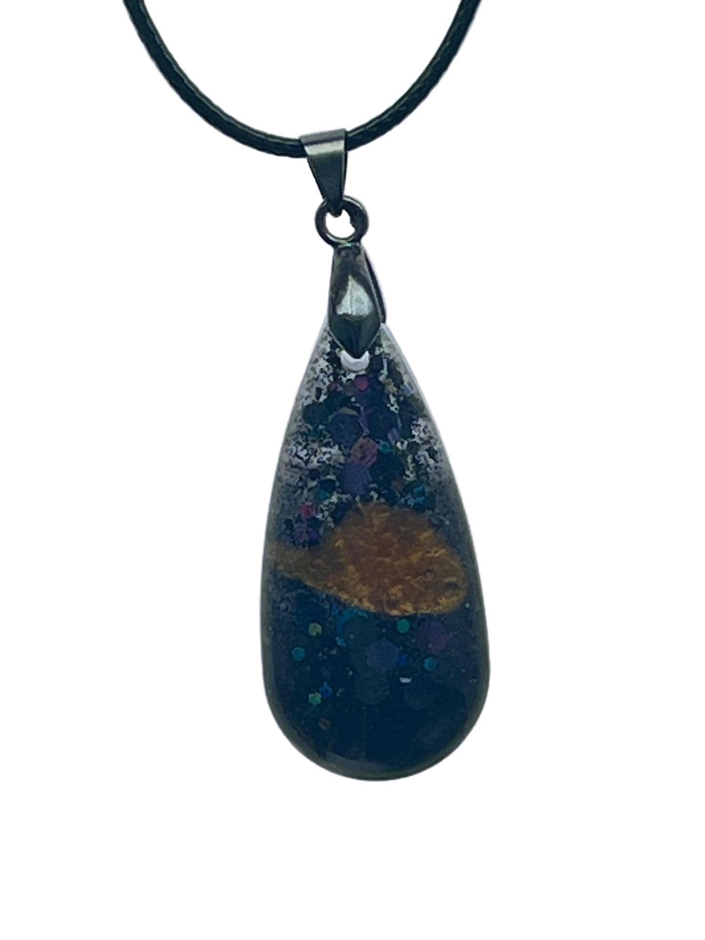 A teardrop-shaped resin pendant in deep navy-black with scattered iridescent violet, teal, and silver speckle, and a single warm amber-gold shape drifting near the center. It hangs from a gunmetal bail on a black braided cord against a pale background.