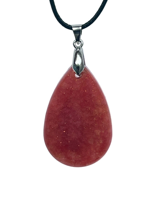 A full, rounded teardrop-shaped resin pendant in deep brick red with a soft saturated glow, scattered throughout with fine gold sparkle. It hangs from a silver-toned bail on a black braided cord against a pale background.