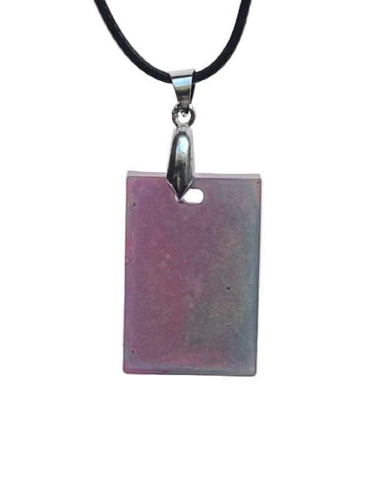 A rectangular resin pendant with a soft gradient from dusty mauve-pink on one side to pale sage-grey with iridescent shimmer on the other. It hangs from a gunmetal bail on a black braided cord against a pale background.