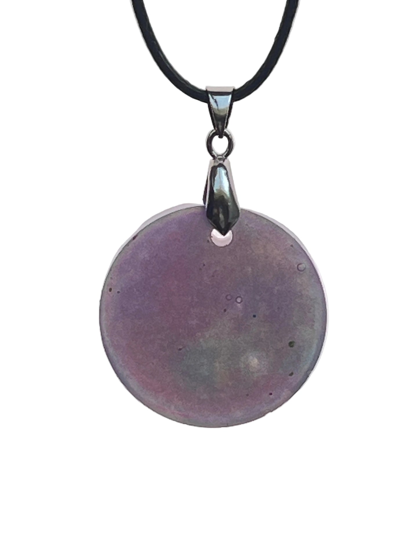 A large round resin pendant in soft violet-grey with subtle sage-green and slate undertones and small bubble-like inclusions. It hangs from a silver-toned bail on a black braided cord against a pale background.